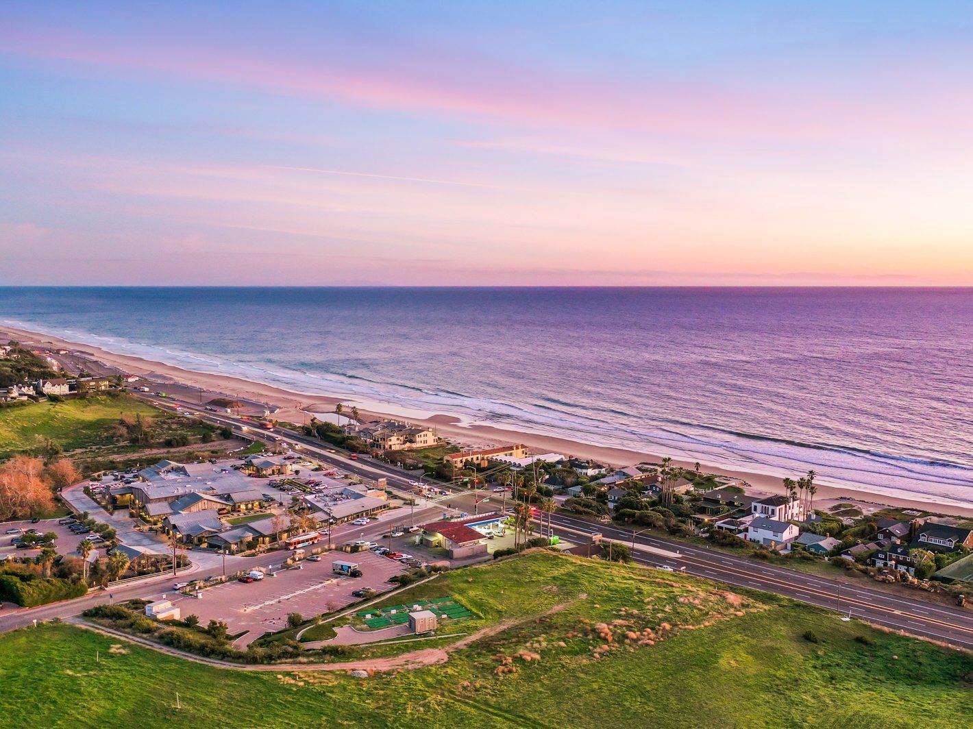 An aerial view of a beach at sunset.