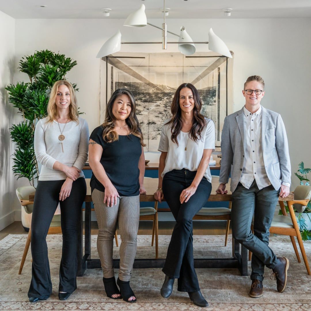 A group of people are posing for a picture in a living room.
