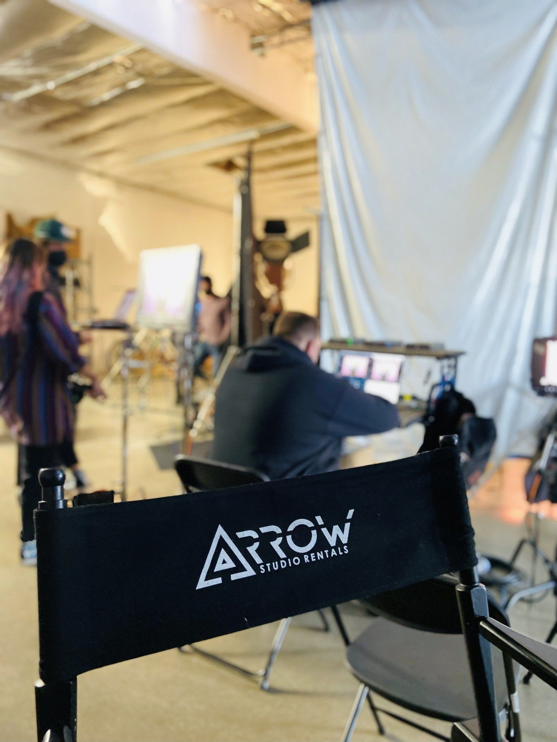 Studio chair with Arrow Studio Rentals logo