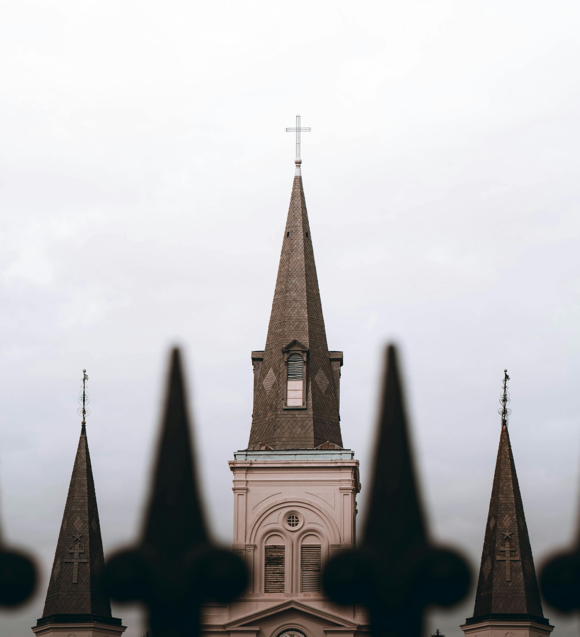 A church with a steeple and a cross on top of it
