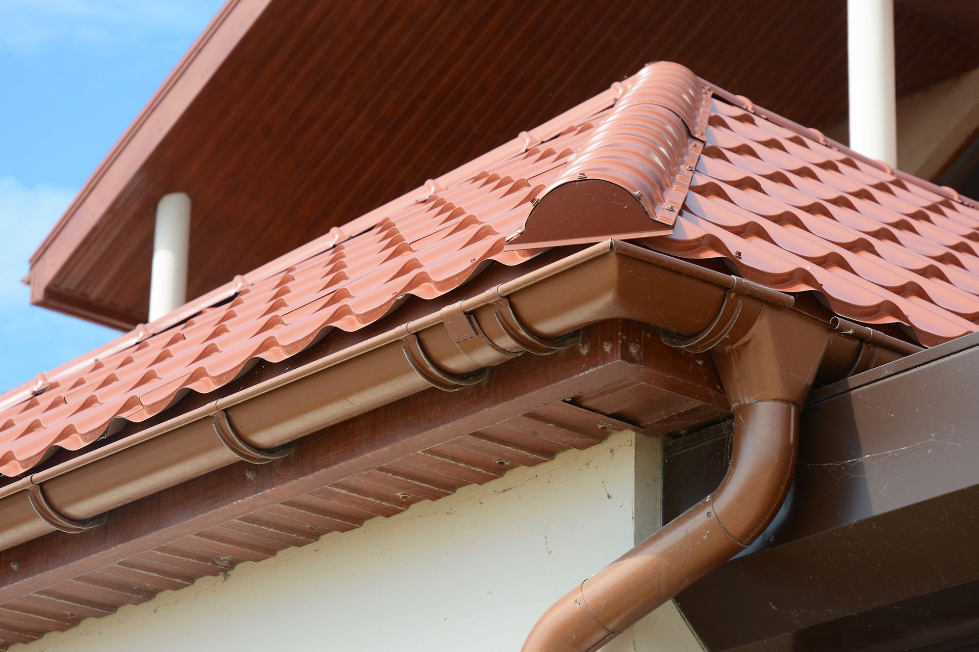 A close up of a gutter on a roof of a house