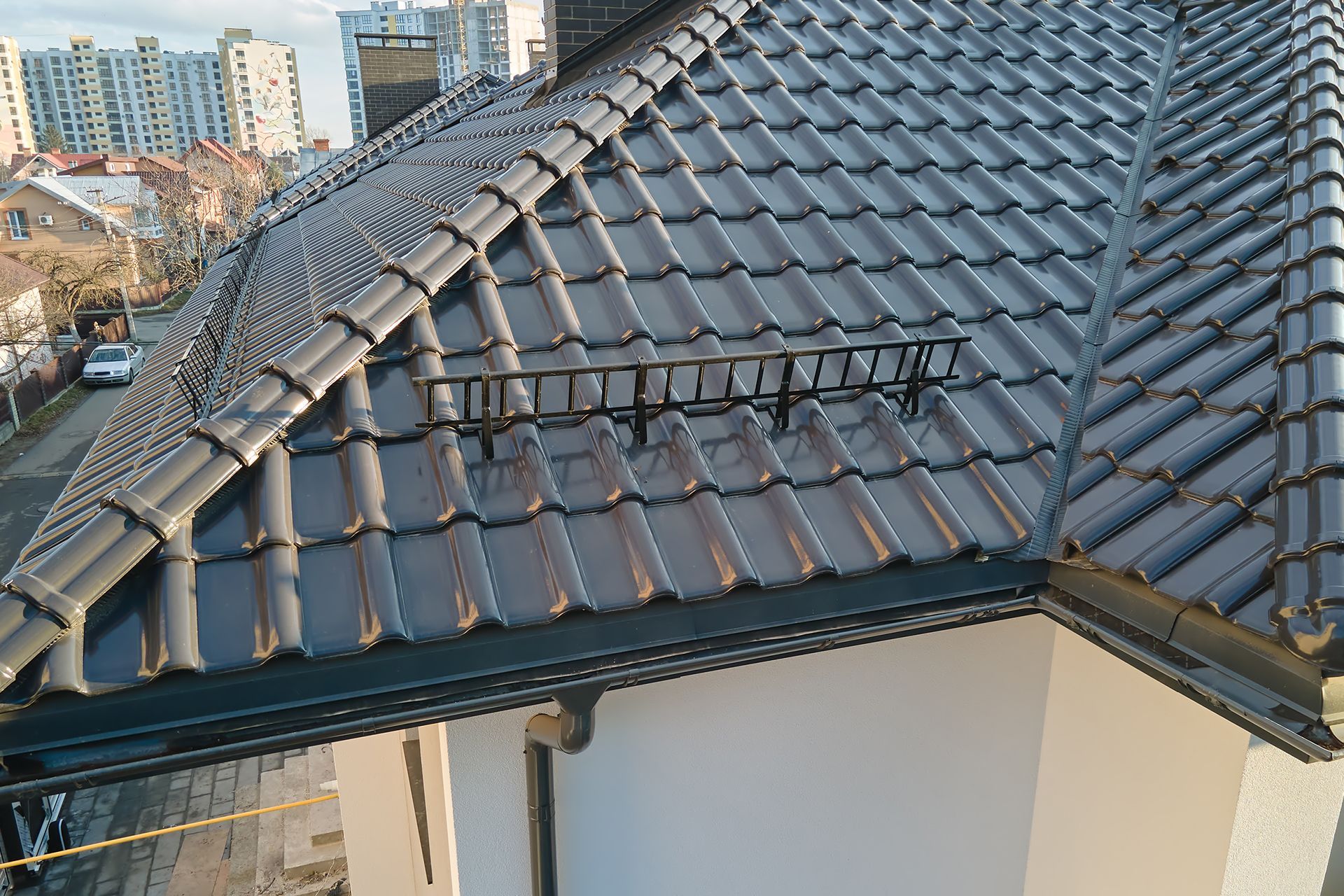 An aerial view of a house with a tiled roof and snow gutters.