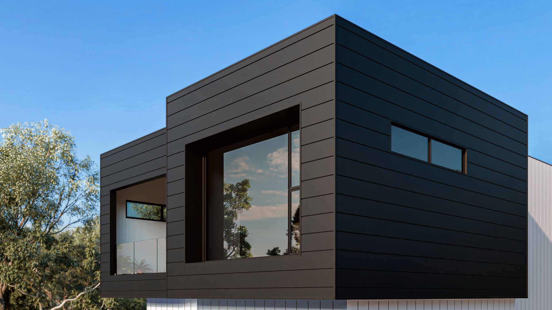 Modern black two-story building with large windows and a minimalist design, blue sky backdrop.
