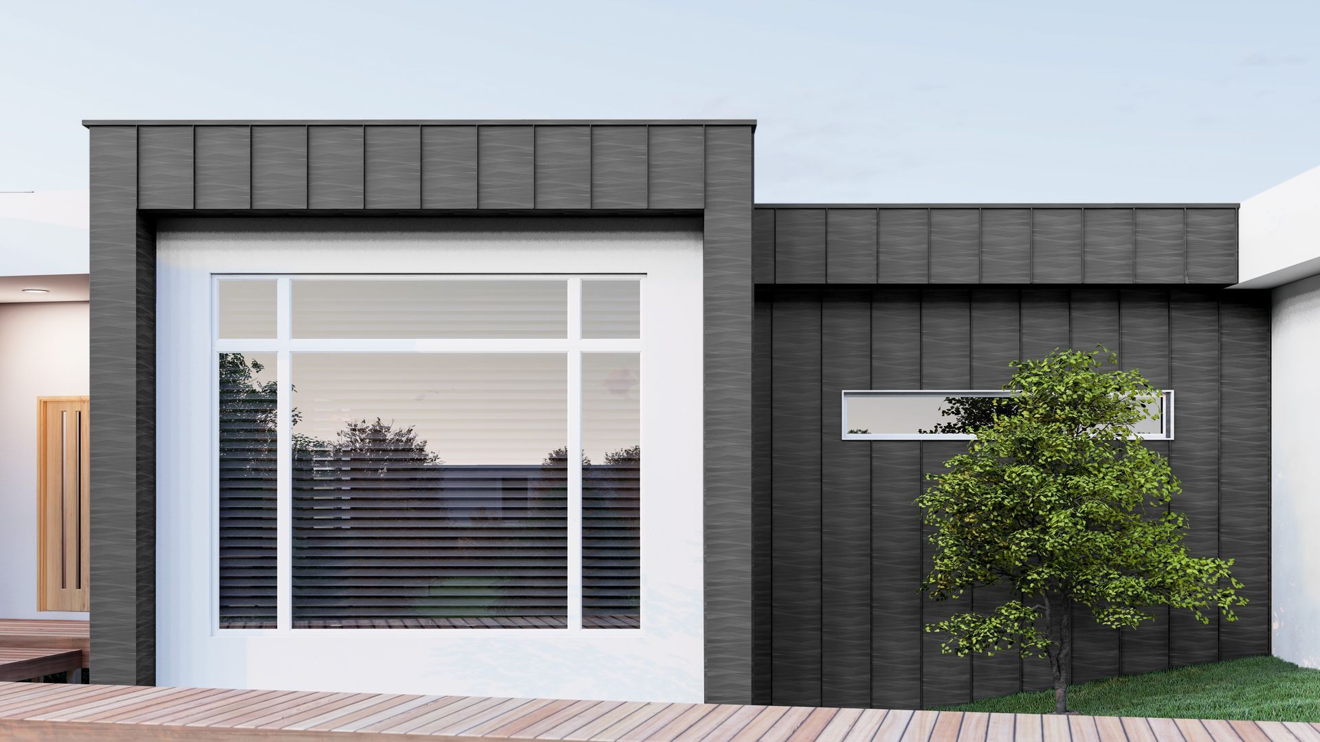 Modern building exterior with dark gray brick facade, large window, and small tree.