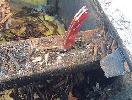 Rotten roof truss embedded in masonry wall pocket needs to be replaced. Red pocket knife stuck in the truss show how soft the support unit is.