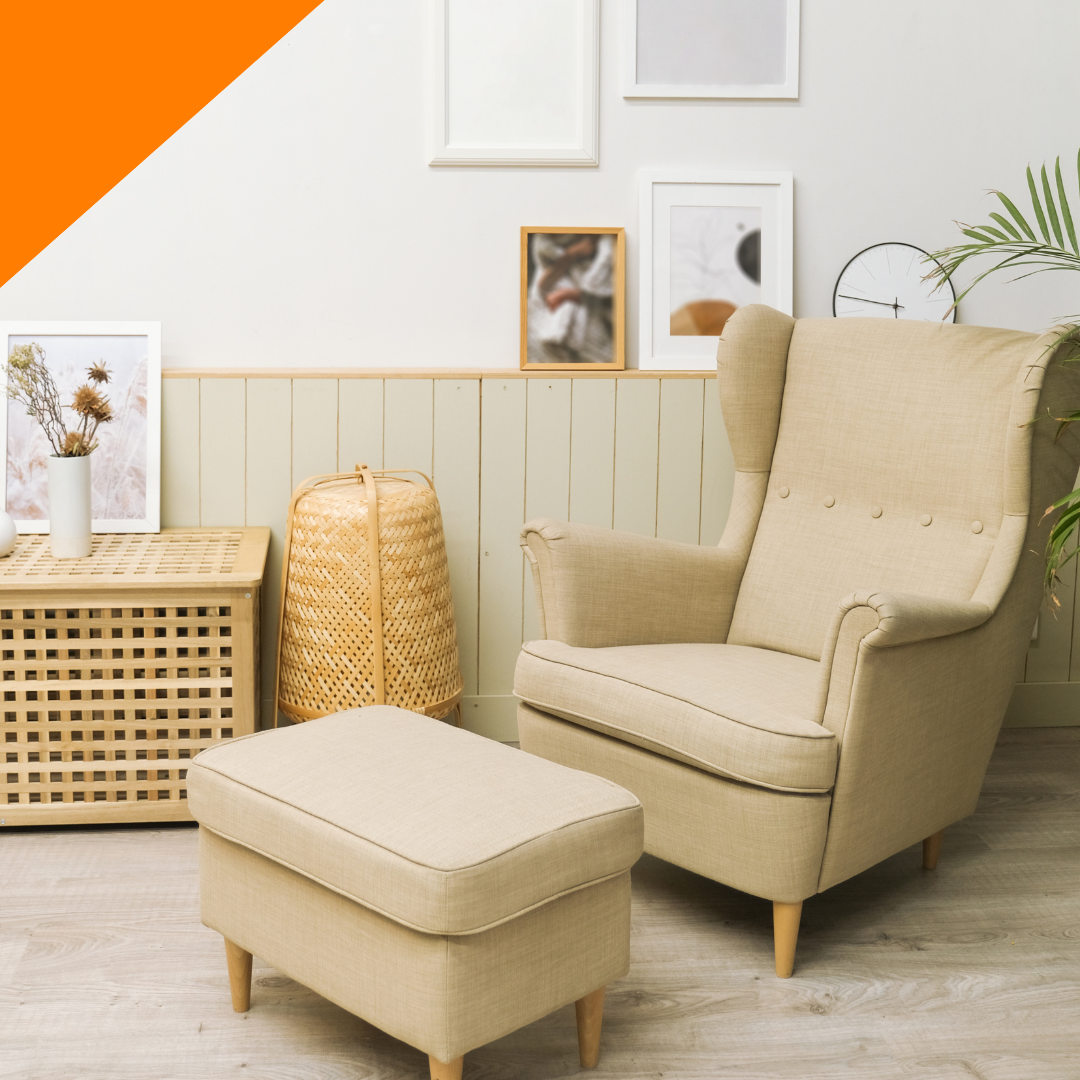 A living room with a chair and an ottoman