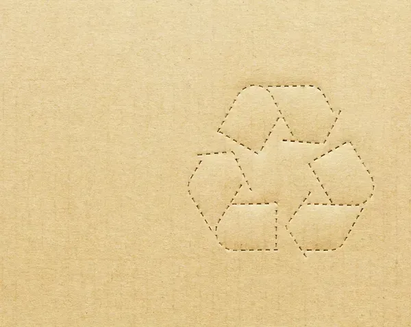A close up of a recycle symbol on a piece of cardboard