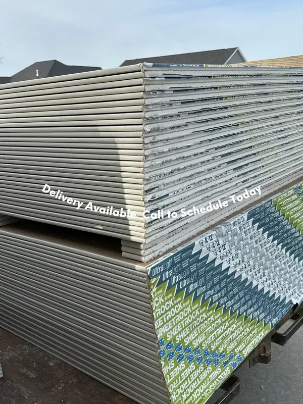 A stack of drywall sheets sitting on top of each other.