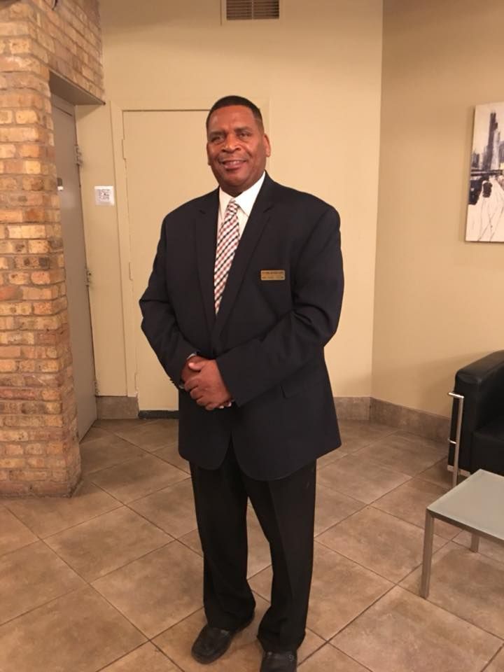 A man in a suit and tie is standing in a room