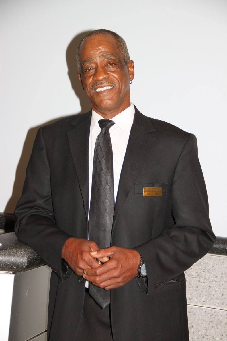 A man in a suit and tie is smiling for the camera.