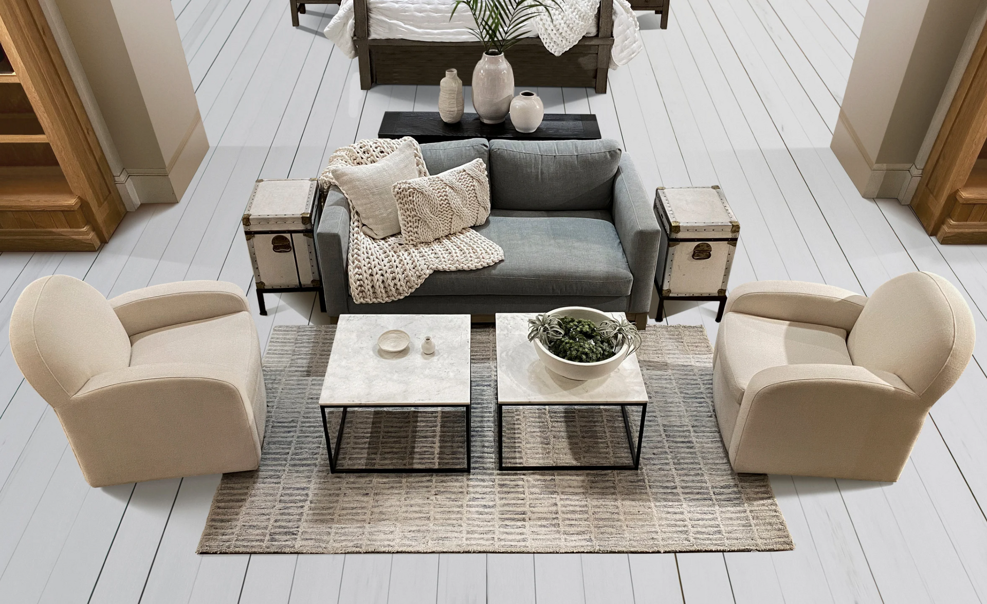 A living room with a couch two chairs and two coffee tables