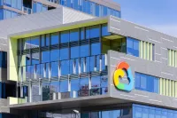 Modern office building exterior with a colorful Google Cloud logo on the facade