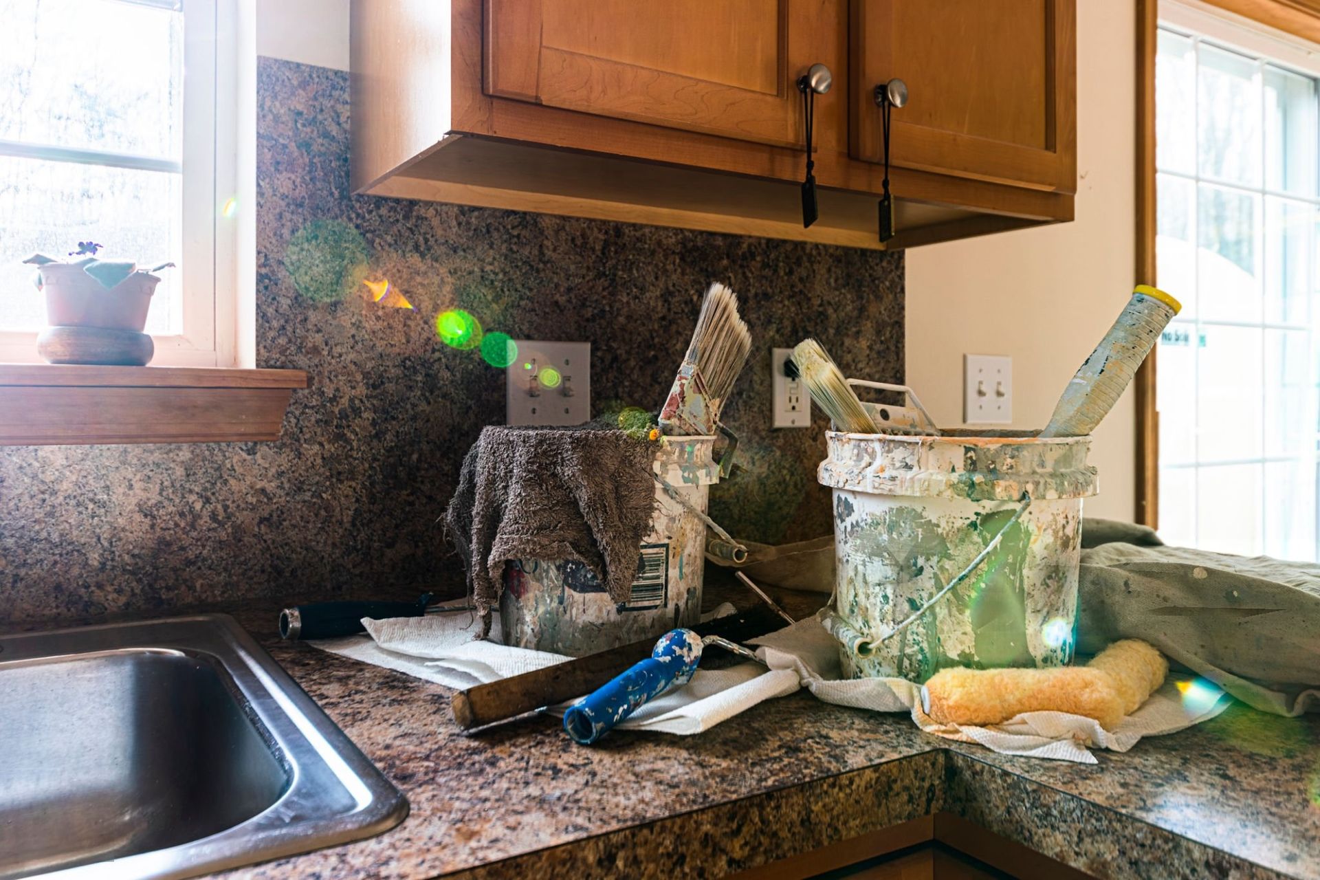 A kitchen with wooden cabinets and a microwave.