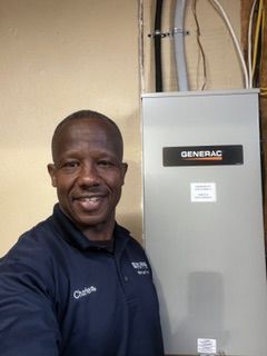 A large, illuminated house with a turret, multiple garage bays, and a wooden facade at dusk.