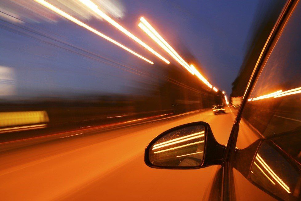 A car speeding at night time.