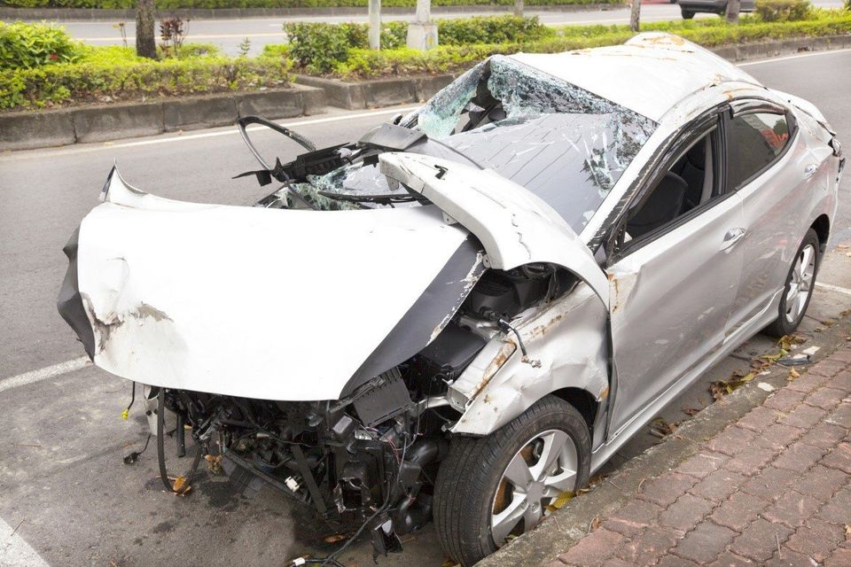 A heavily damaged car after an accident.