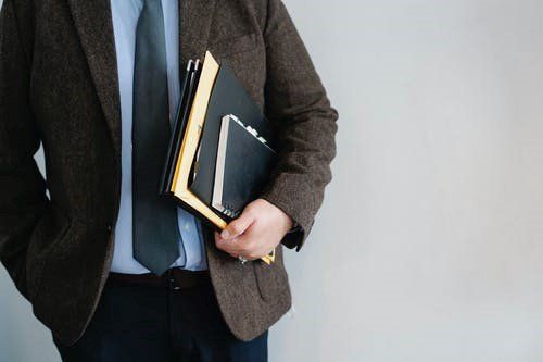 A lawyer holding a case file while heading to the office.
