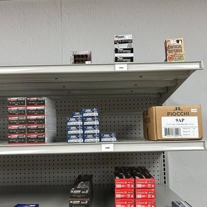 Shelves stocked with various ammunition boxes; a retail setting.