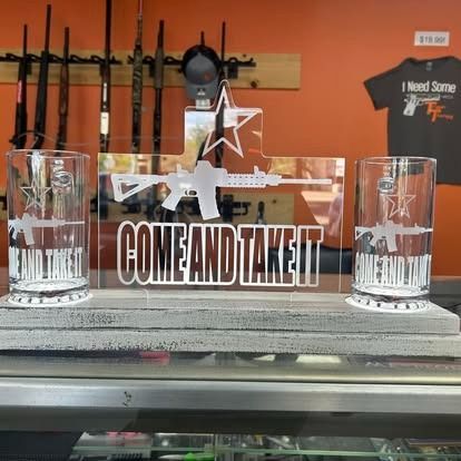 Display with engraved glasses and AR-15 imagery, featuring 