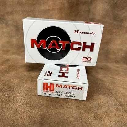 Two boxes of Hornady Match 224 Valkyrie ammunition, white with red lettering, stacked on brown fabric.
