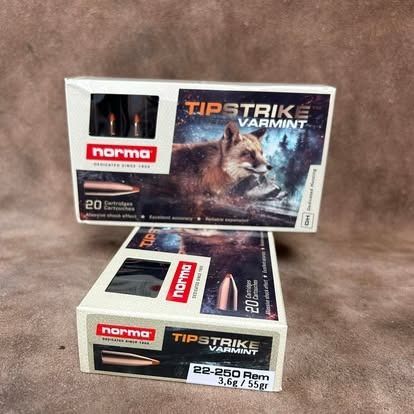 Two boxes of Norma Tipstrike Varmint .22-250 ammo, featuring a fox image and bullets on a surface.