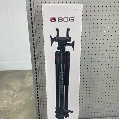 Box of a black BOG DeathGrip tripod against a wall.