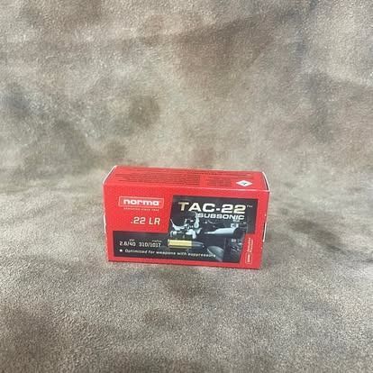 Red box of Norma TAC-22 .22 LR ammunition on a gray surface.