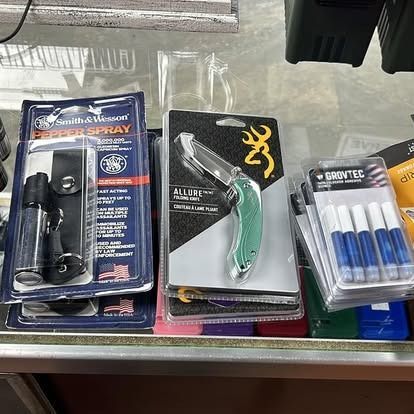 Display of self-defense items: pepper spray, a knife, and glue.