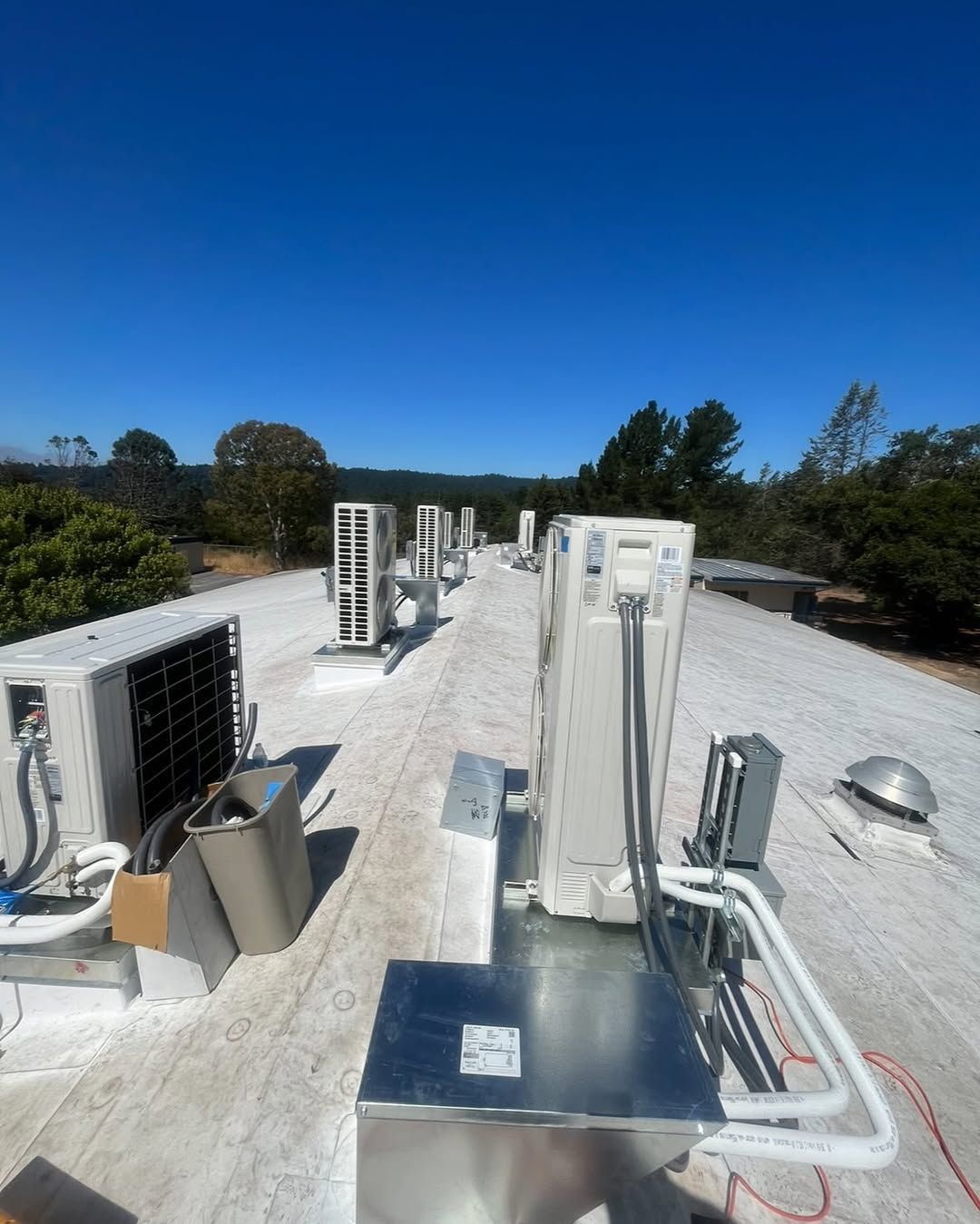 A roof with a lot of air conditioners on it
