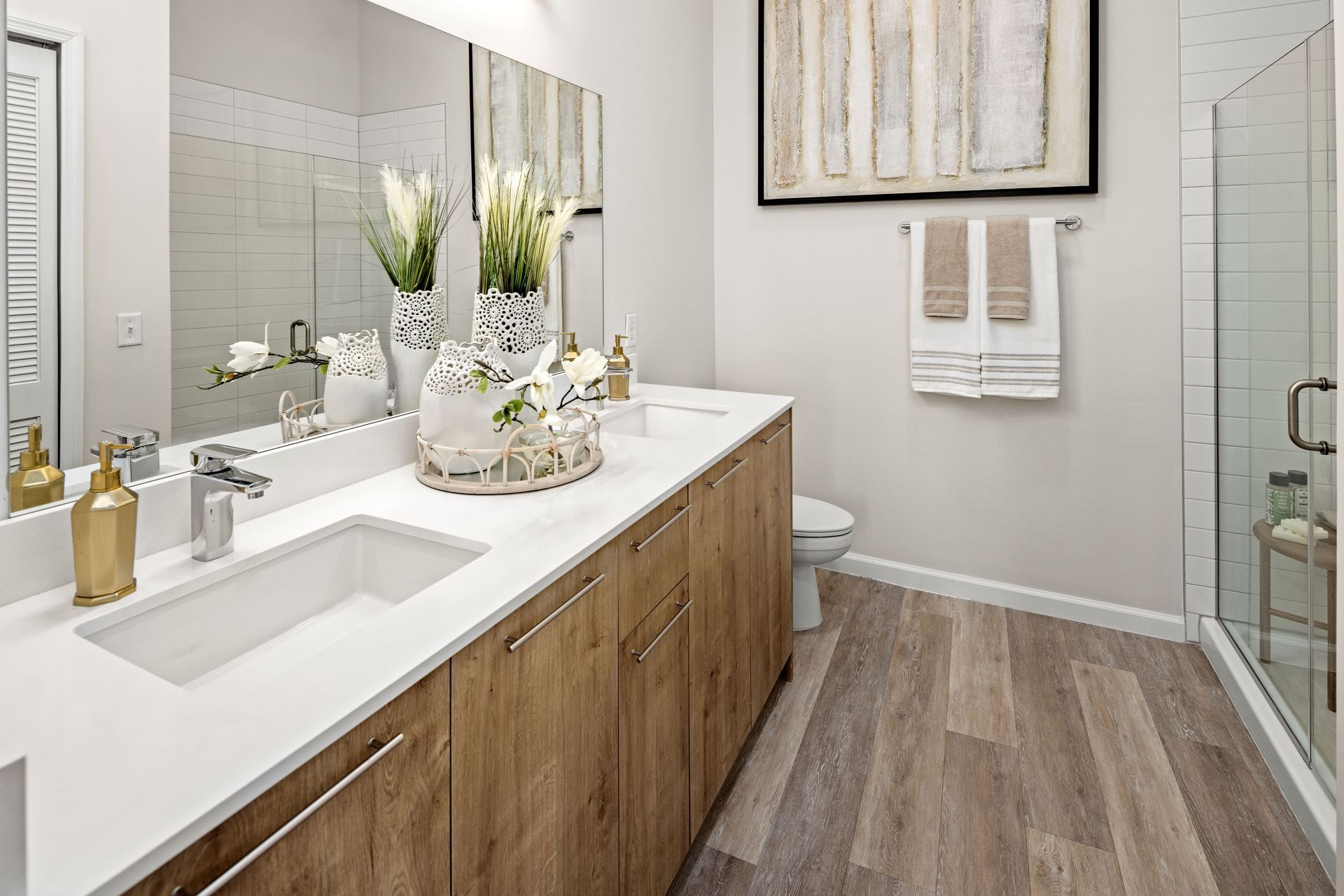 A bathroom with a sink , toilet , and shower.