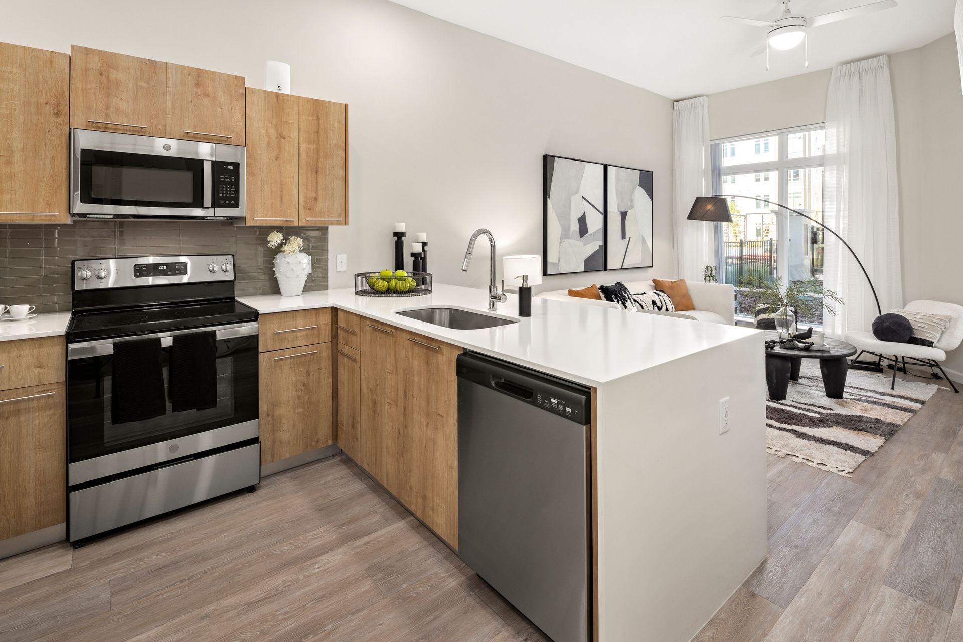 An artist 's impression of a kitchen with stainless steel appliances and wooden cabinets.