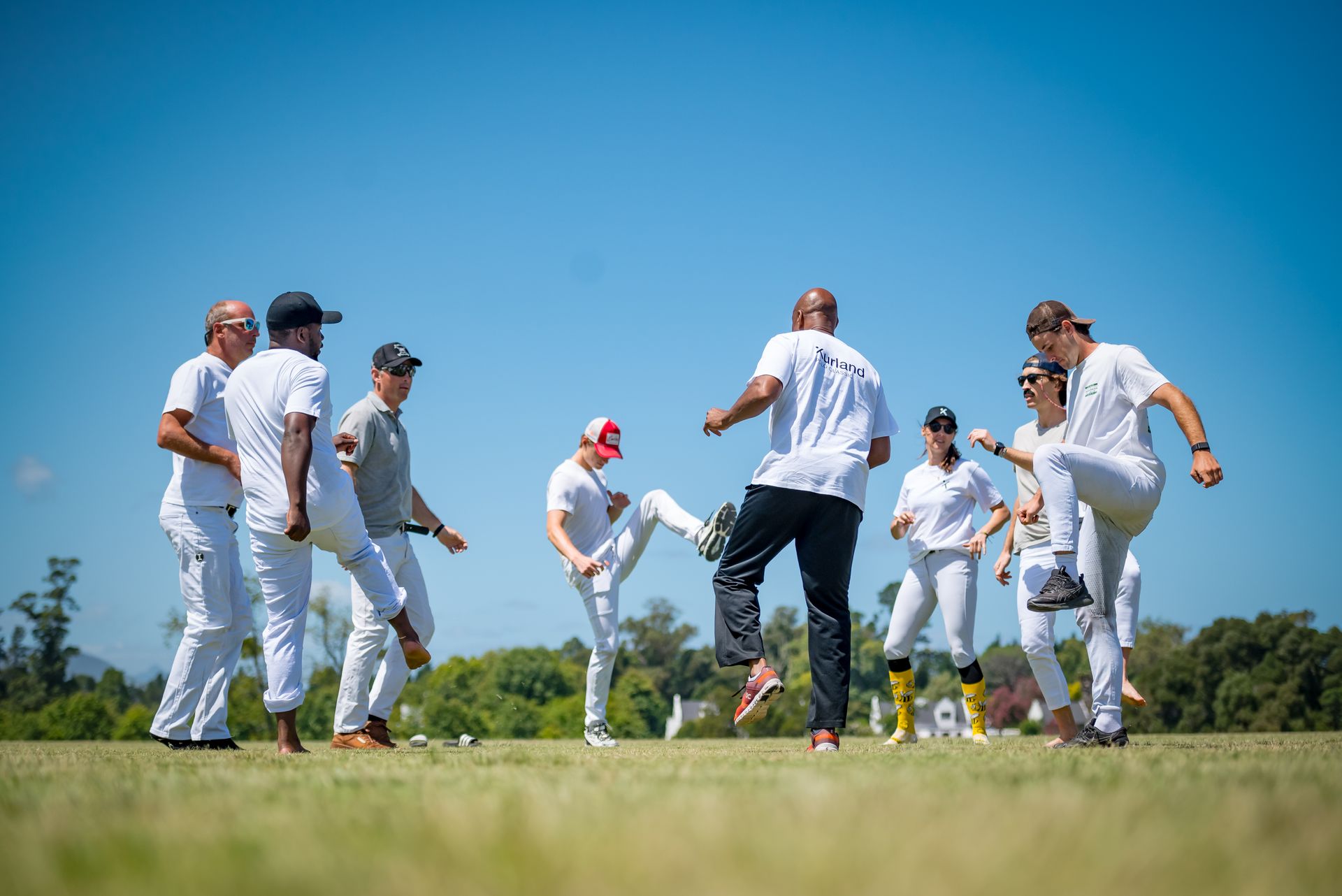 A group of people are playing soccer on a field.