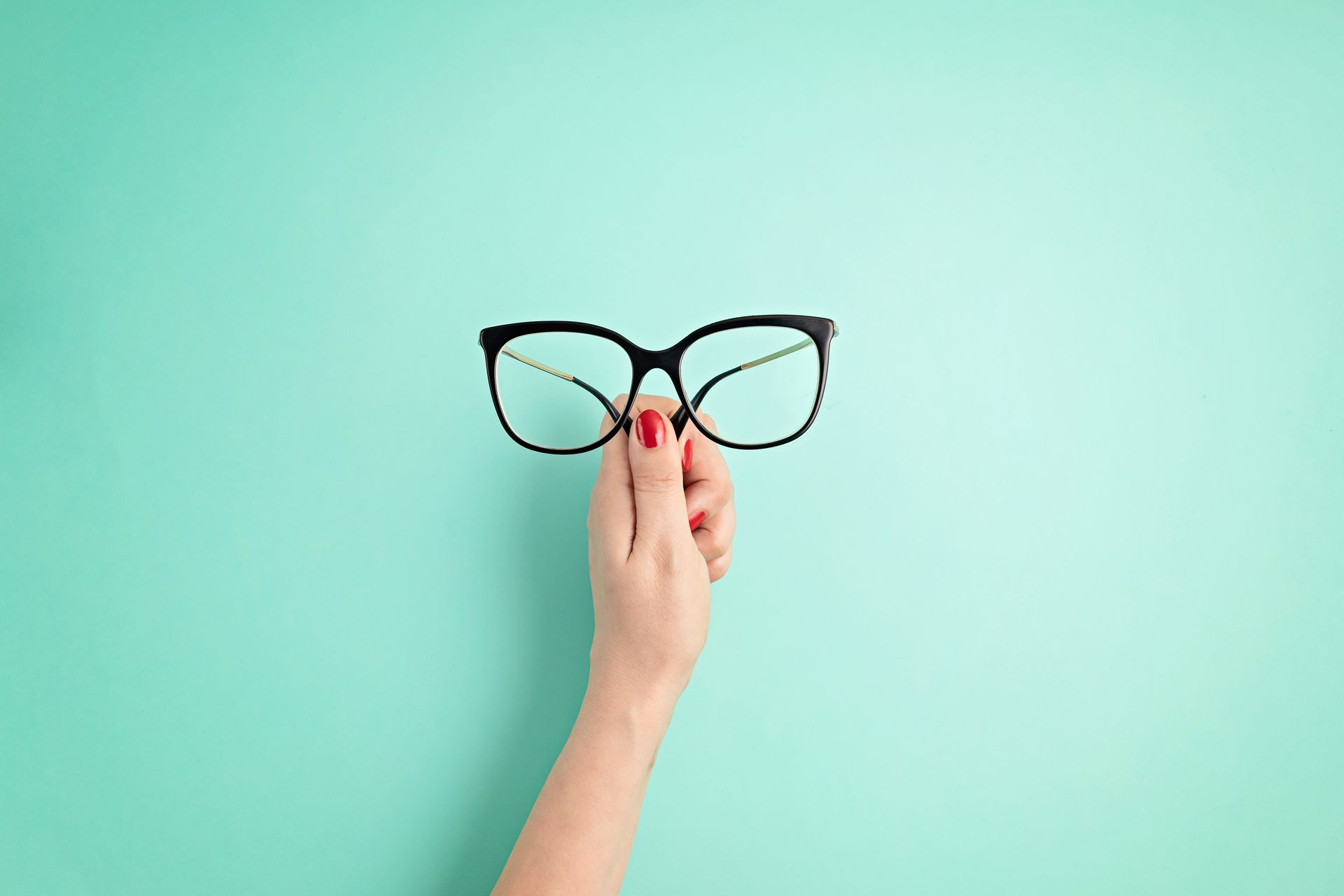 woman hand holding eyeglasses optical store