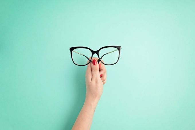 woman hand holding eyeglasses optical store