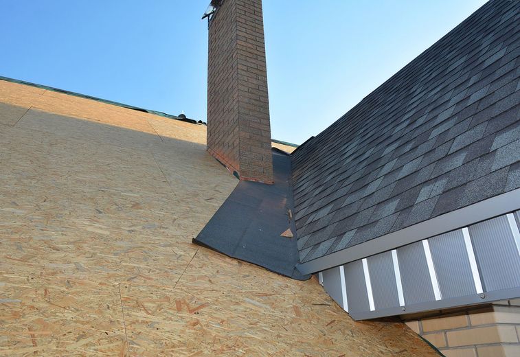 A roof with shingles and a chimney on it