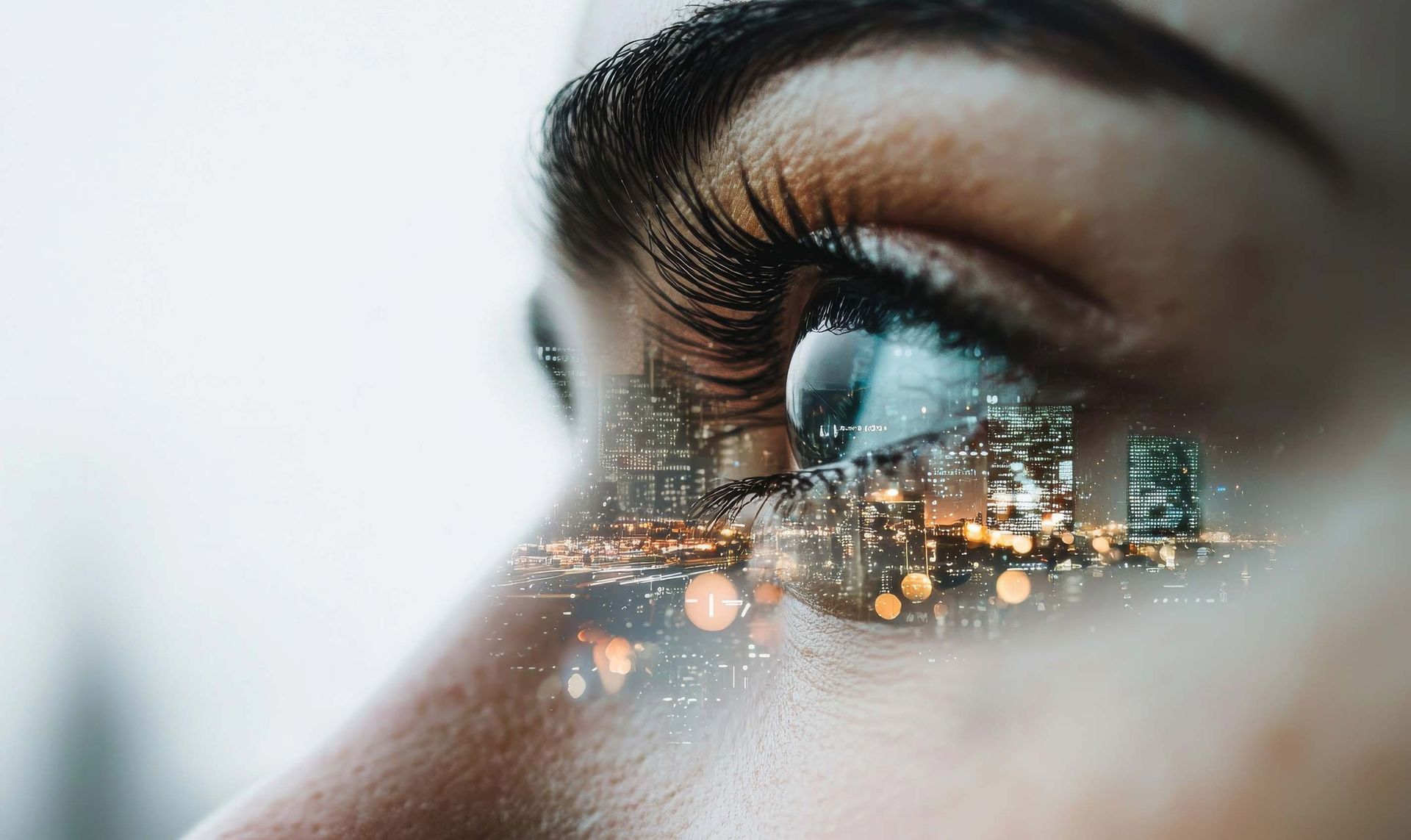 A close up of a woman 's eye with a city skyline reflected in it.