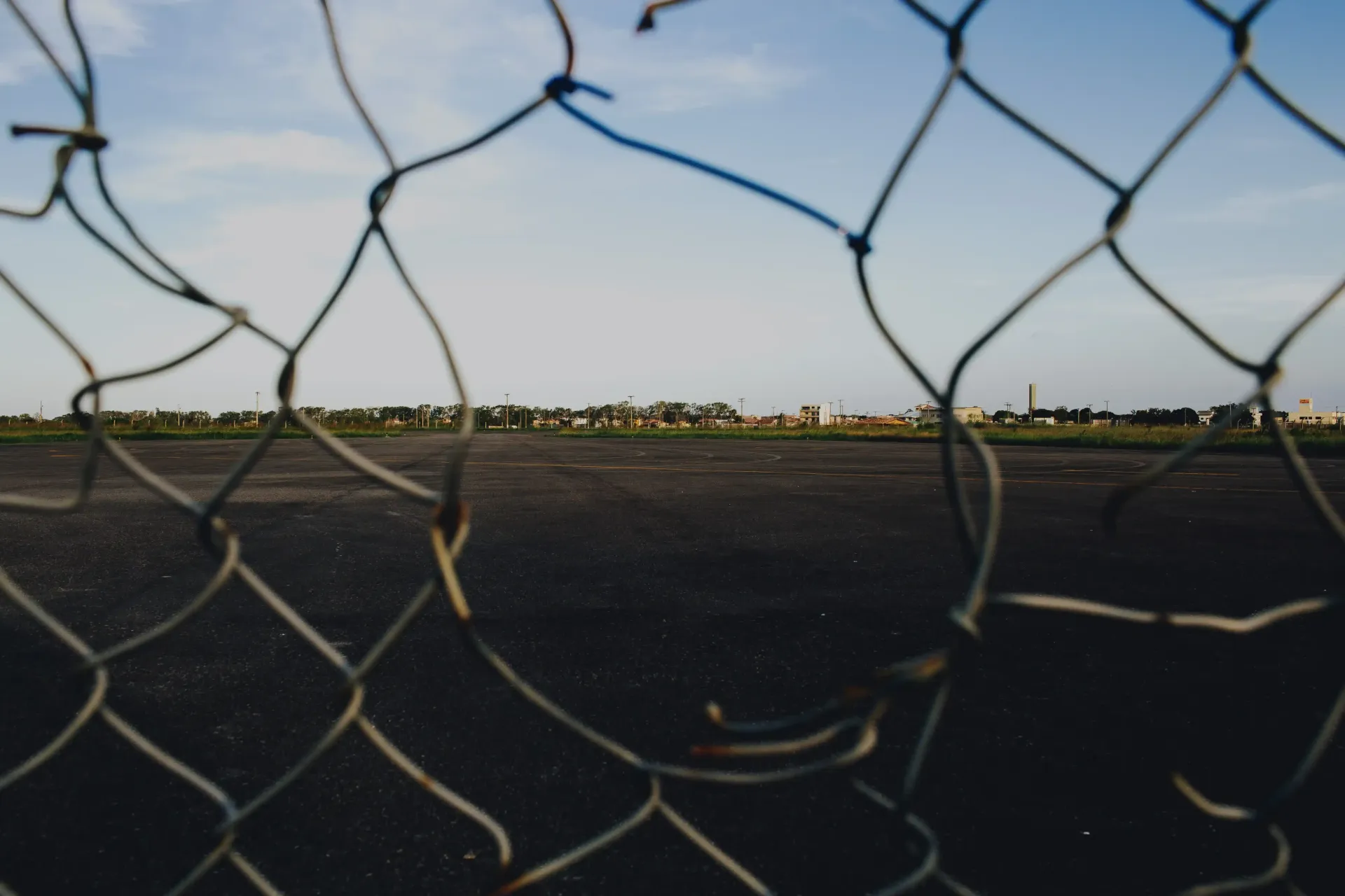 A chain link fence with a hole in it