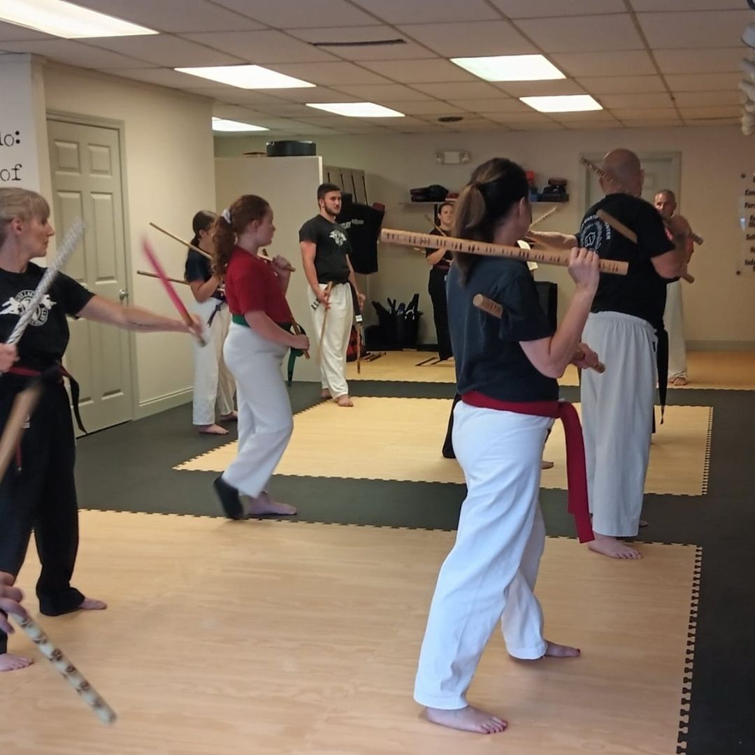 Four men in athletic gear, posing for a photo in a gym.