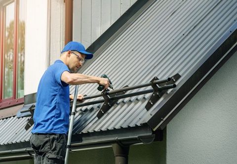 Roofer Installing Snow Guard on Metal Roof — Livonia, MI — Billy's Roofing