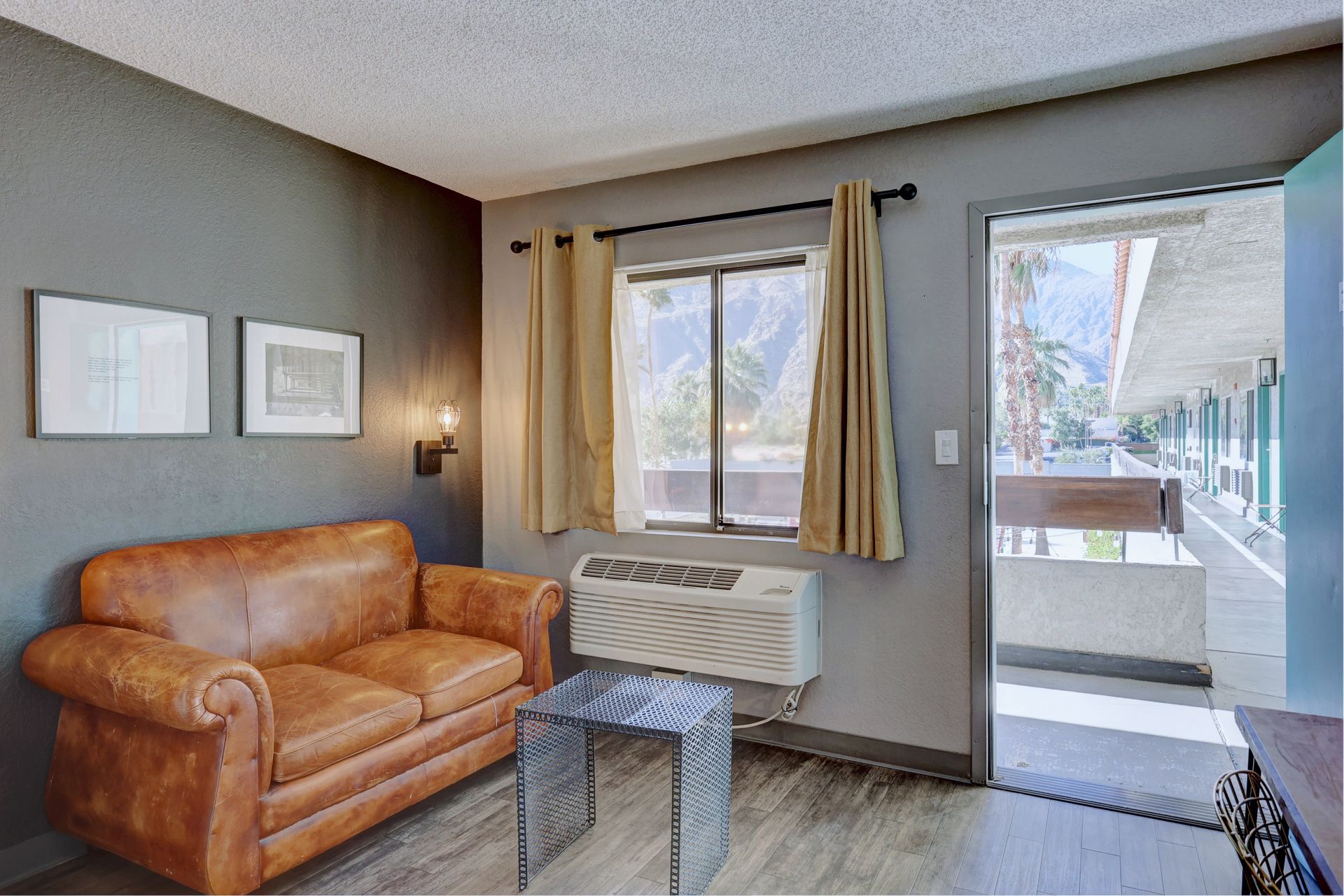 A living room with a couch , table , and window.
