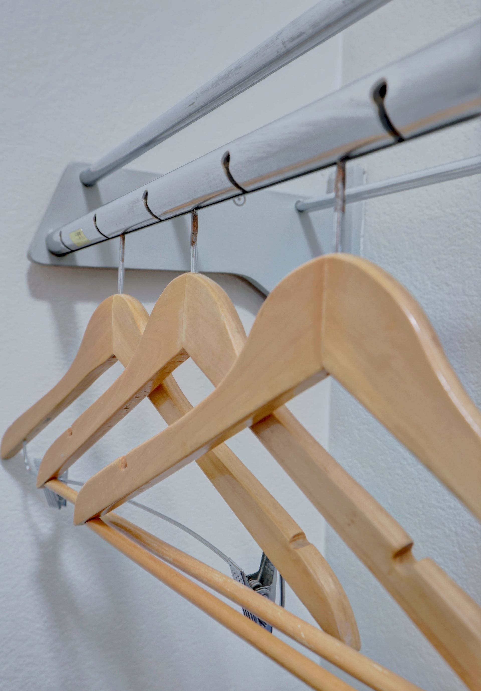 A row of wooden hangers hanging on a rack