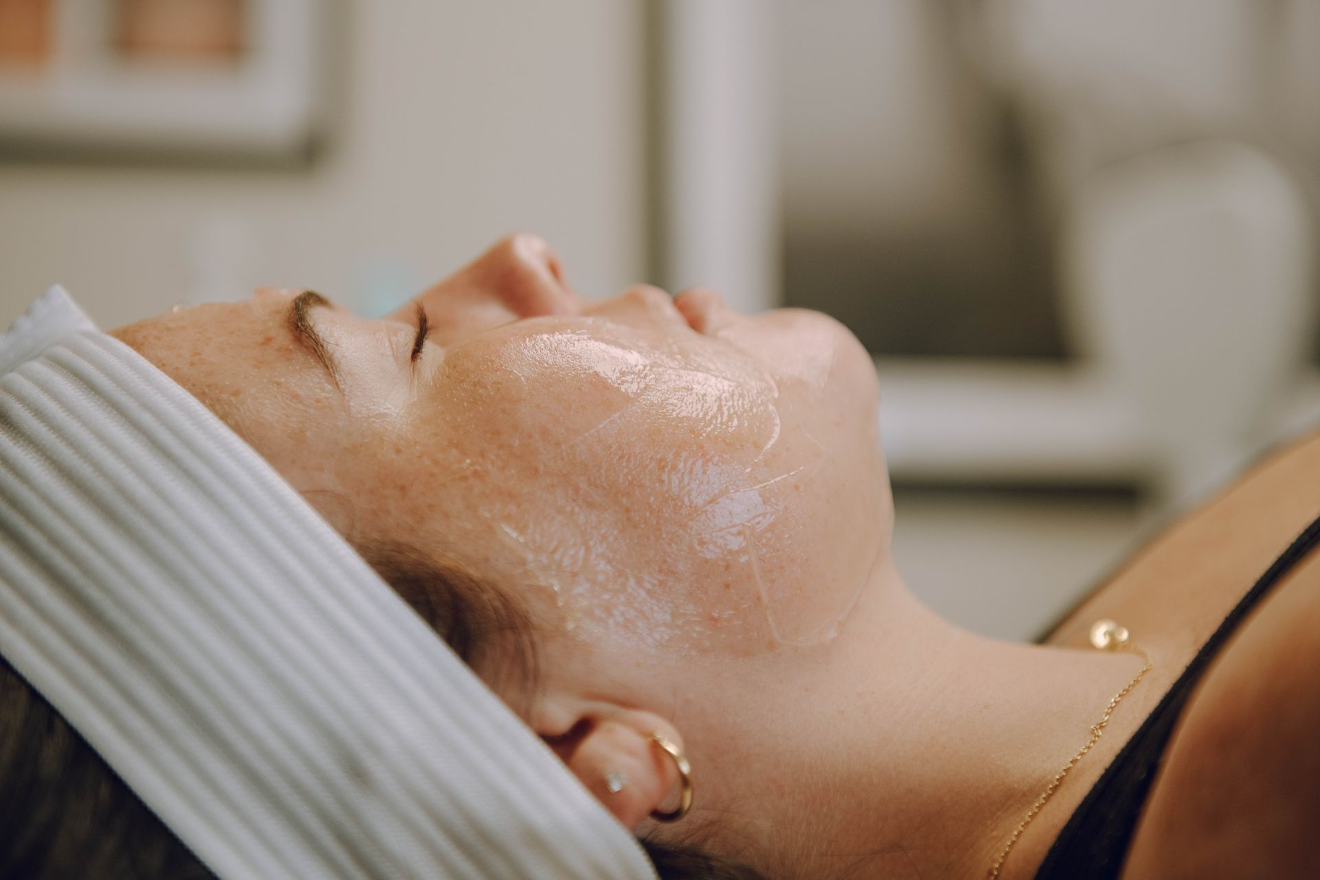 A Woman is Laying on a Bed getting a Facial Treatment — Auburndale, FL — Ultra Cryo & Recovery