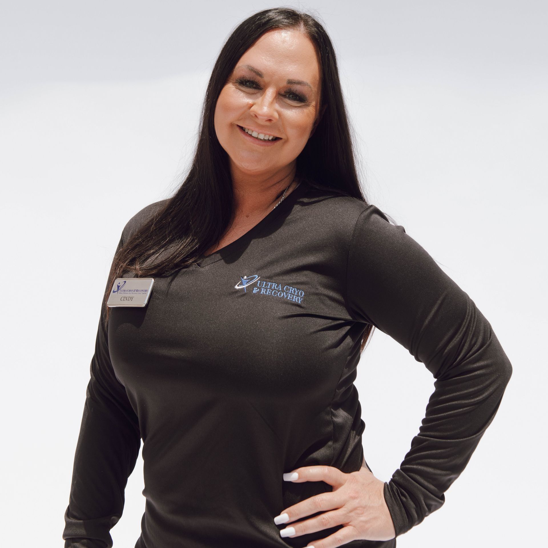 A woman wearing a black shirt with a butterfly embroidered on it