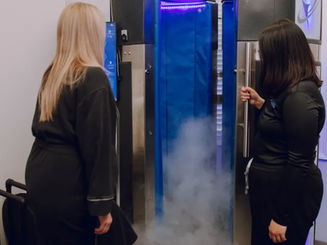 A woman entering the full body cryotherapy chamber at Ultra Cryo & Recovery in Auburndale.