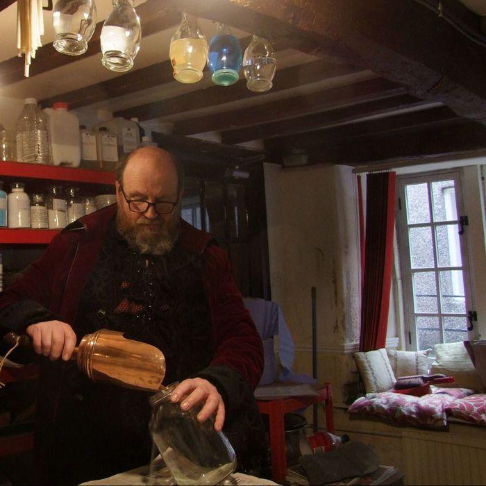 The artist making pigments in his workshop