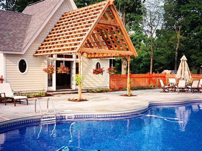 A swimming pool with a house in the background