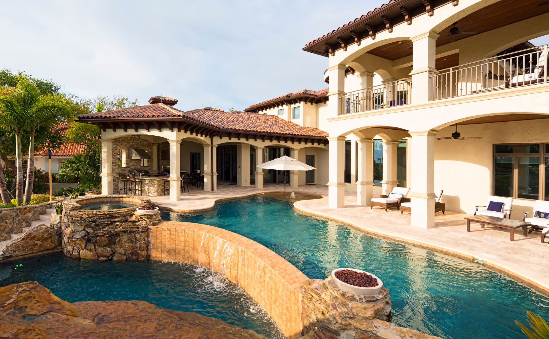 A large house with a large swimming pool in front of it