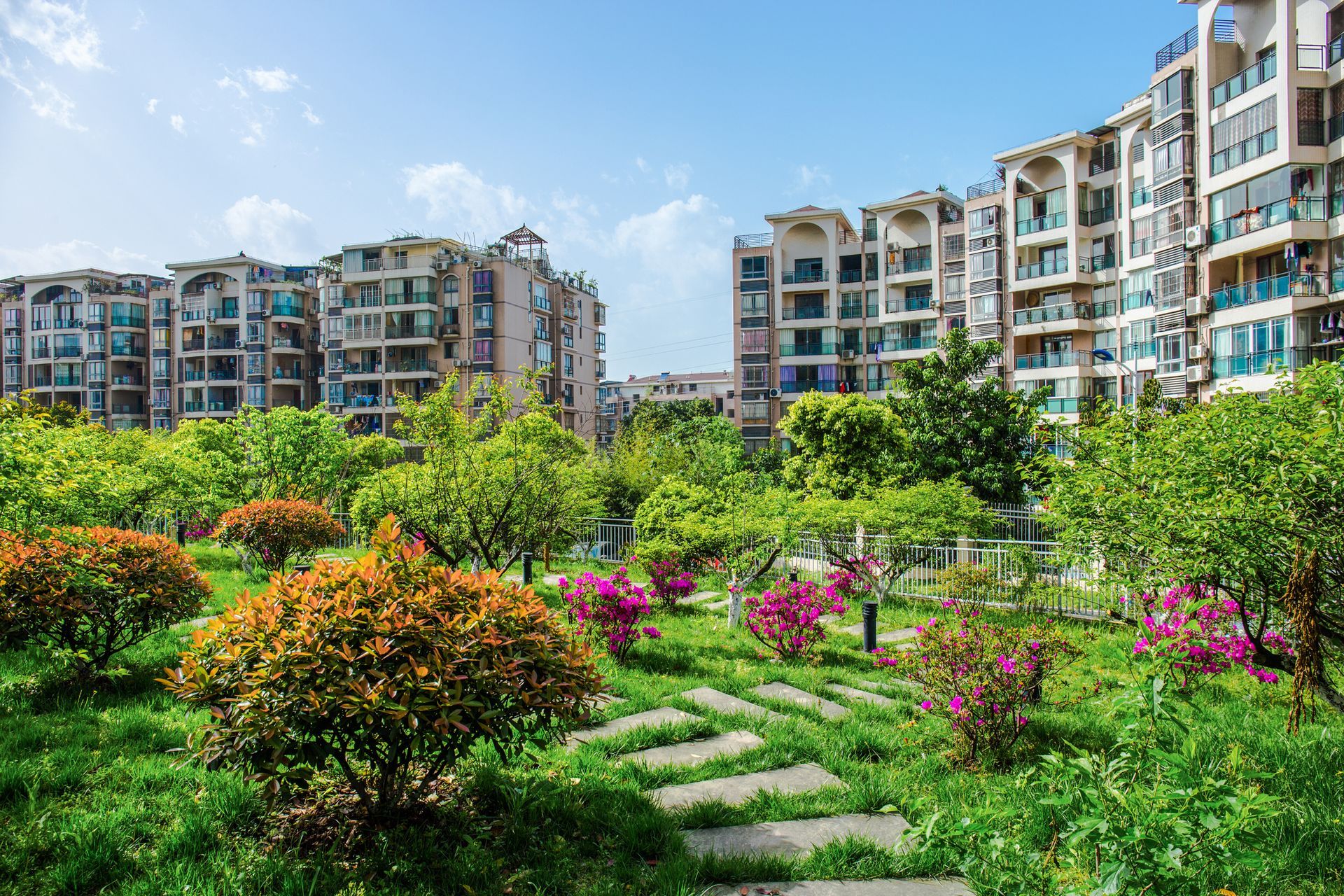 There are a lot of buildings in the background and a park in the foreground.