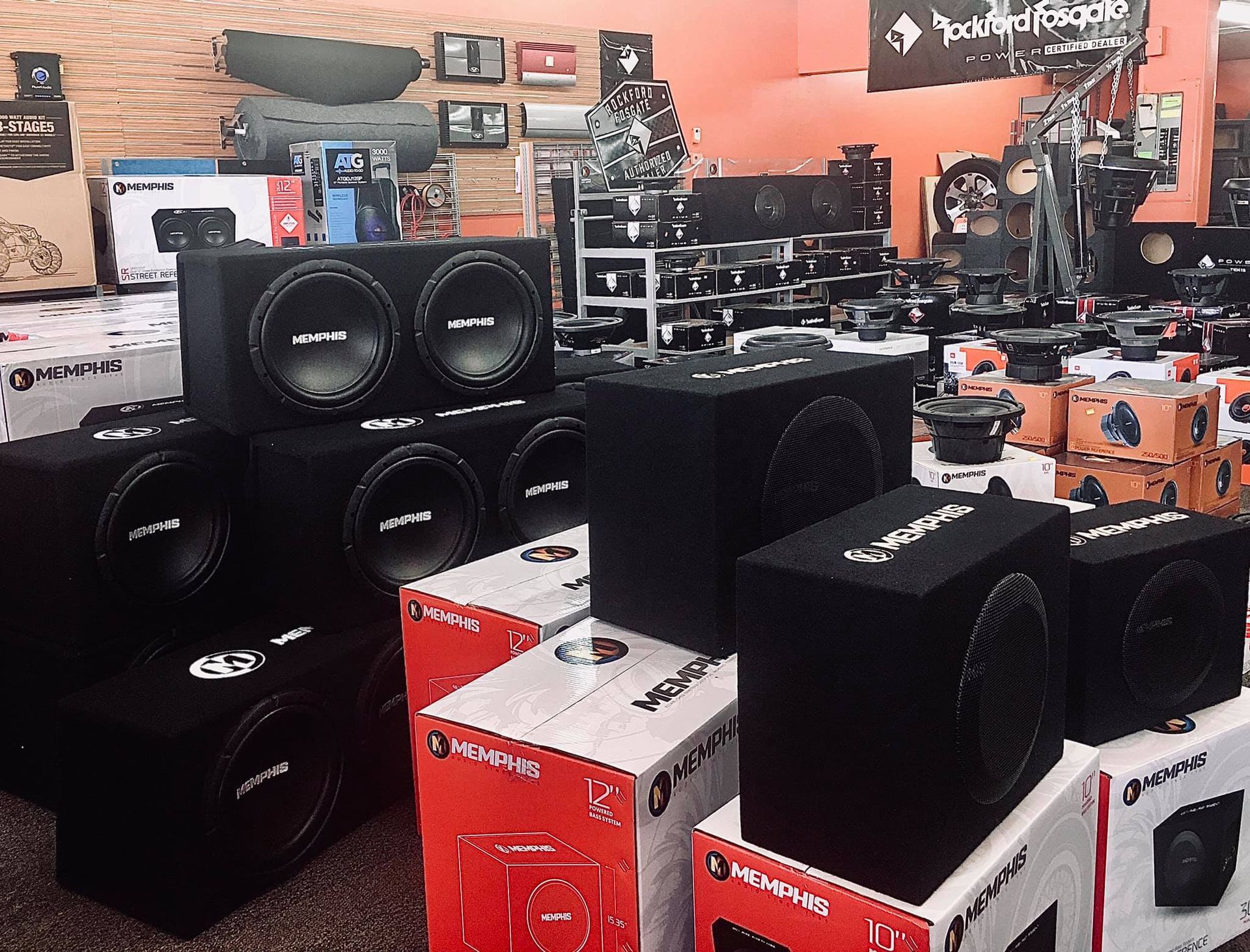 A store interior with many black subwoofer boxes and boxes.