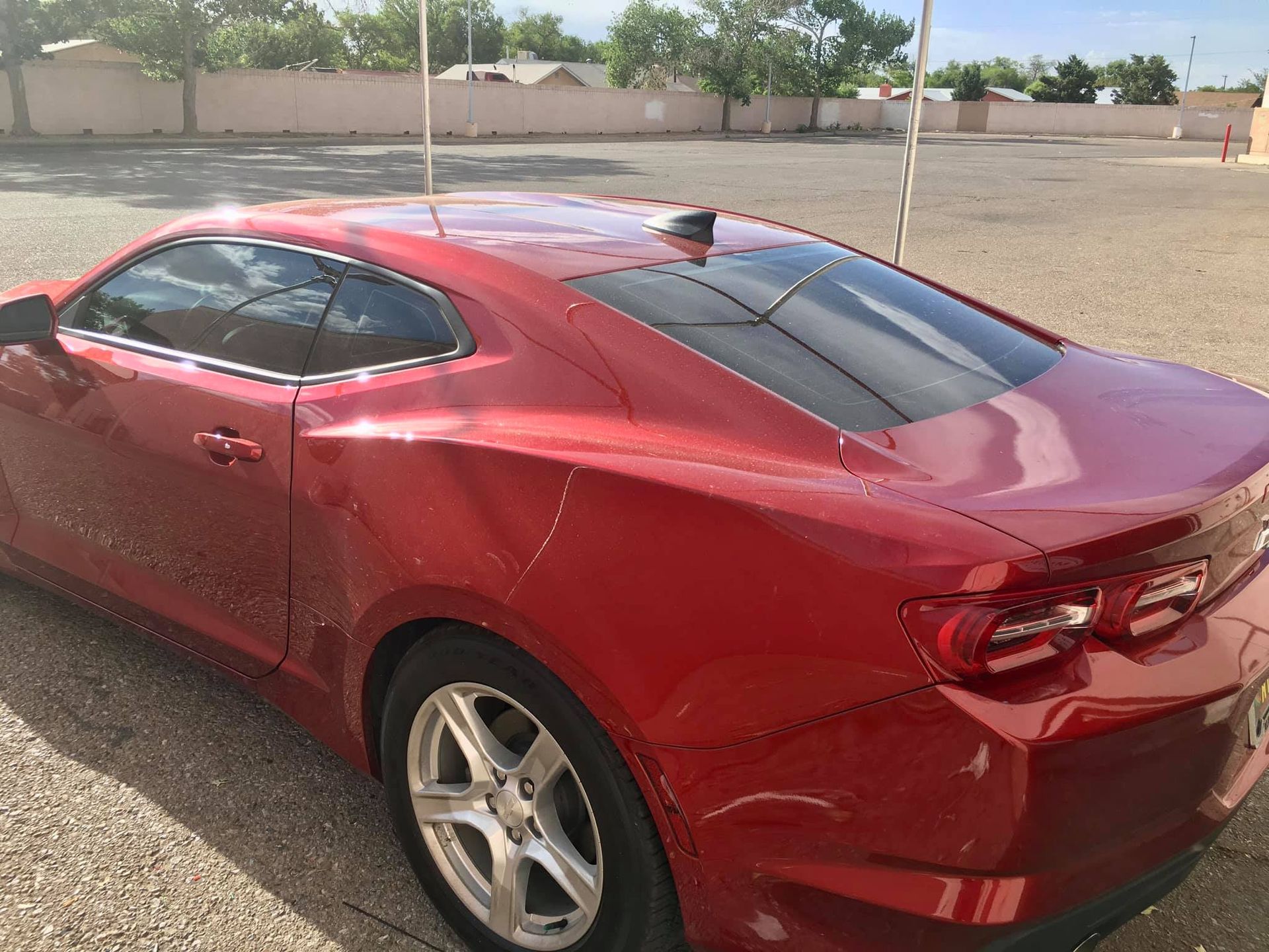 Red Chevrolet Camaro parked outdoors.